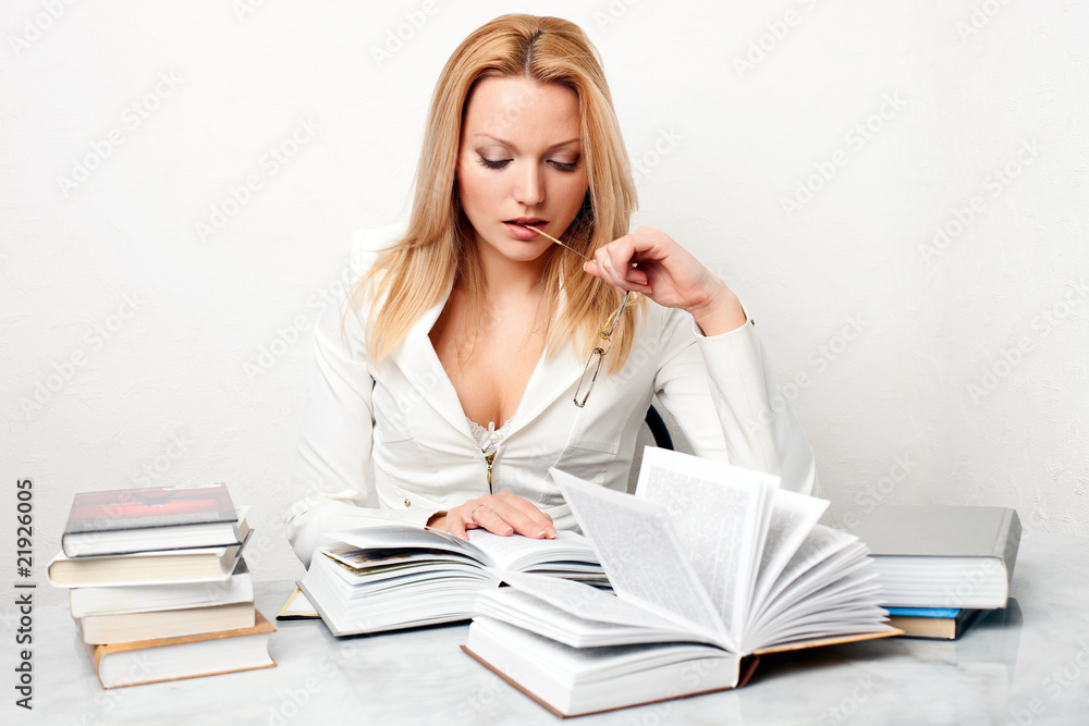 Young woman holding glasses at table with books Young woman holding glasses at table with books