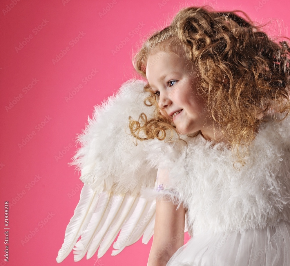 Beautiful little angel girl isolated on pink background Beautiful little angel girl isolated on pink background