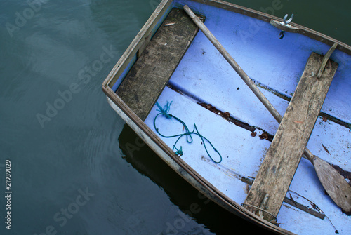 Canvas Print A portion of an aged rowboat on the water taken from above