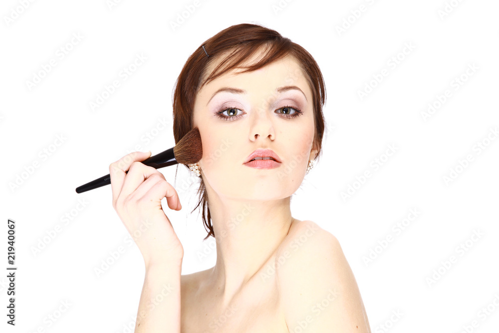 Portrait of attractive young woman applying blusher. Portrait of attractive young woman applying blusher.