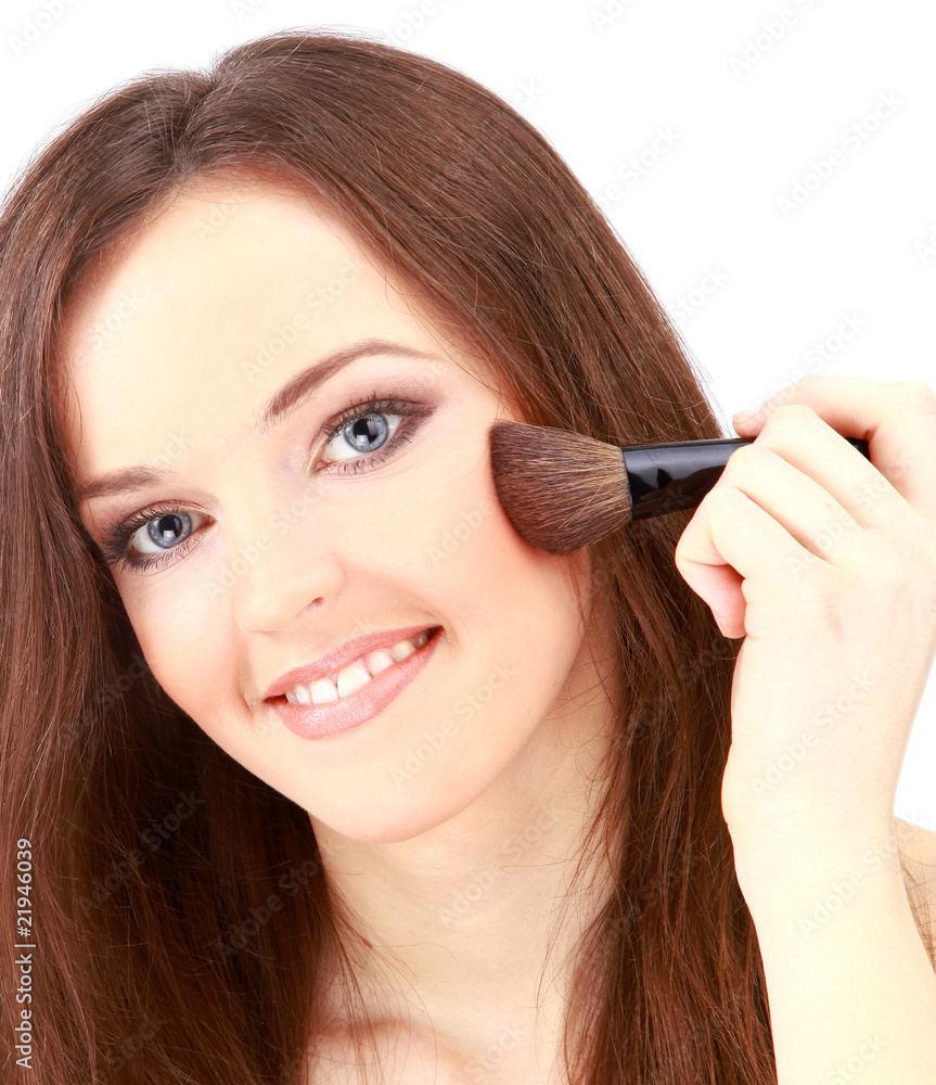 Portrait of attractive young woman applying blusher. Portrait of attractive young woman applying blusher.