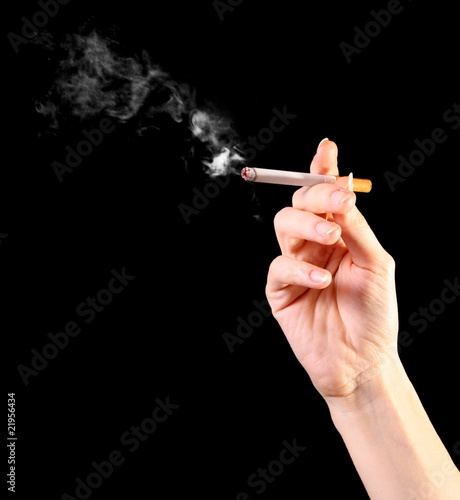 woman hand holding a cigarette with smoke