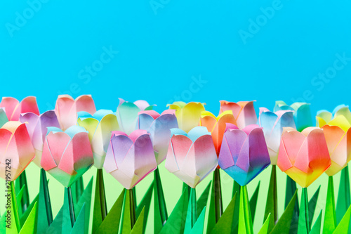 Paper tulips field with a blue background