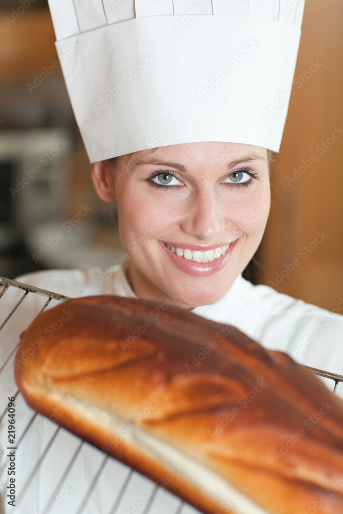 Cheerful female chef baking bread Cheerful female chef baking bread