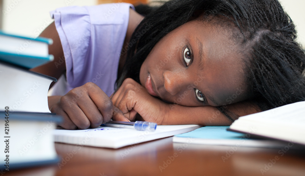 Exhausted Afro-American woman resting while studying Exhausted Afro-American woman resting while studying