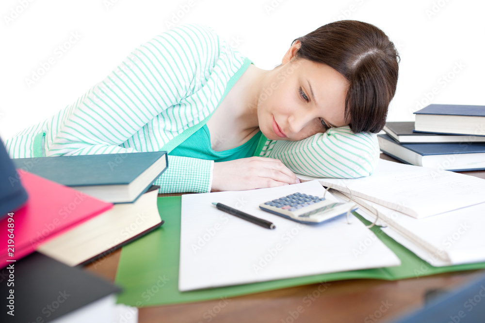 Exhausted bright woman studying on a table Exhausted bright woman studying on a table