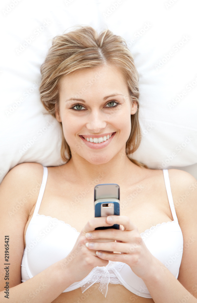 Happy woman in underwear sending a text Happy woman in underwear sending a text