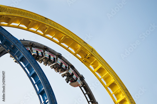Fototapeta Naklejka Na Ścianę i Meble -  Rollercoaster looping ride on fun fair