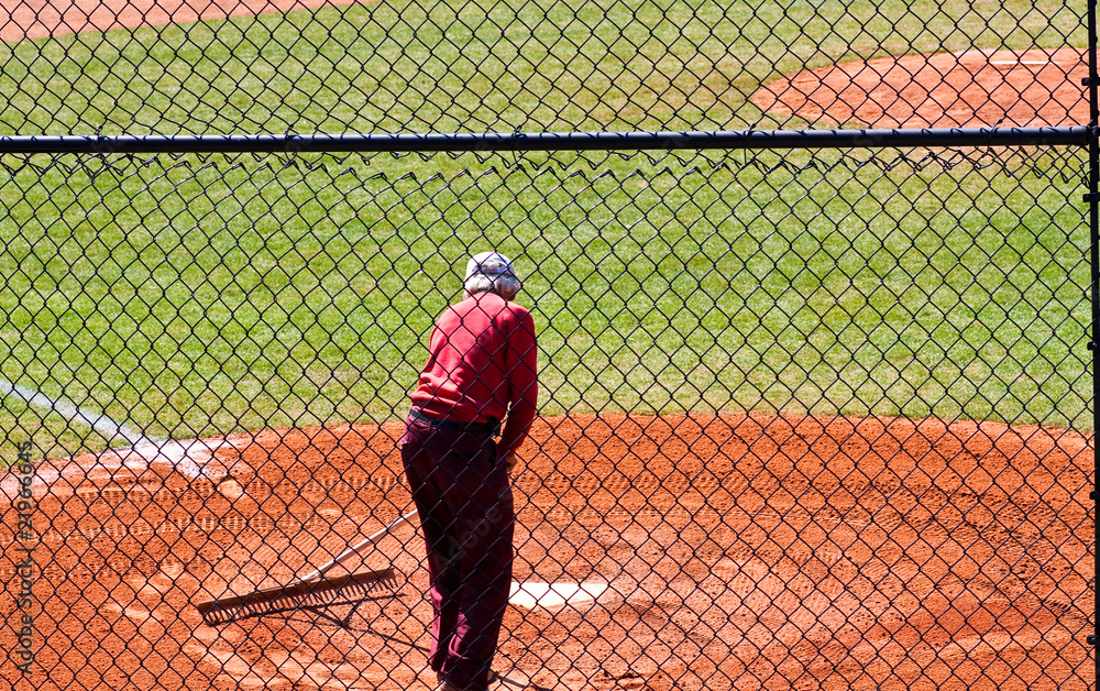 Groundskeeper Working Baseball Field
