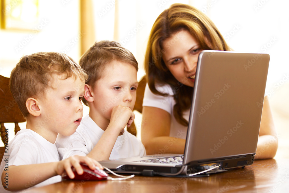 mother with her children using laptop