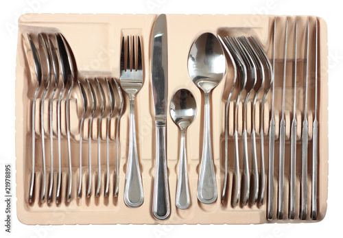 Cutlery set into packing isolated on white with clipping path