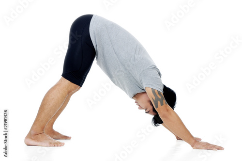 Portrait of a handsome young man in yoga stance