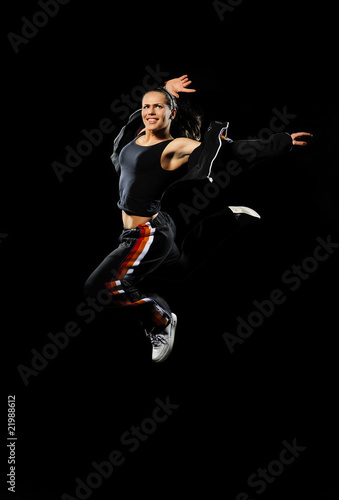 Female dancer jumping on a black background