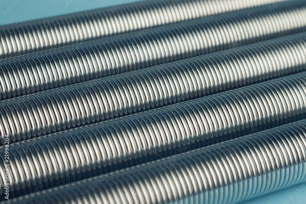 metal coil springs on blue background with selective focus metal coil springs on blue background with selective focus