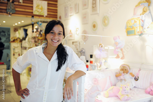 small business owner: proud woman opening her baby shop photo