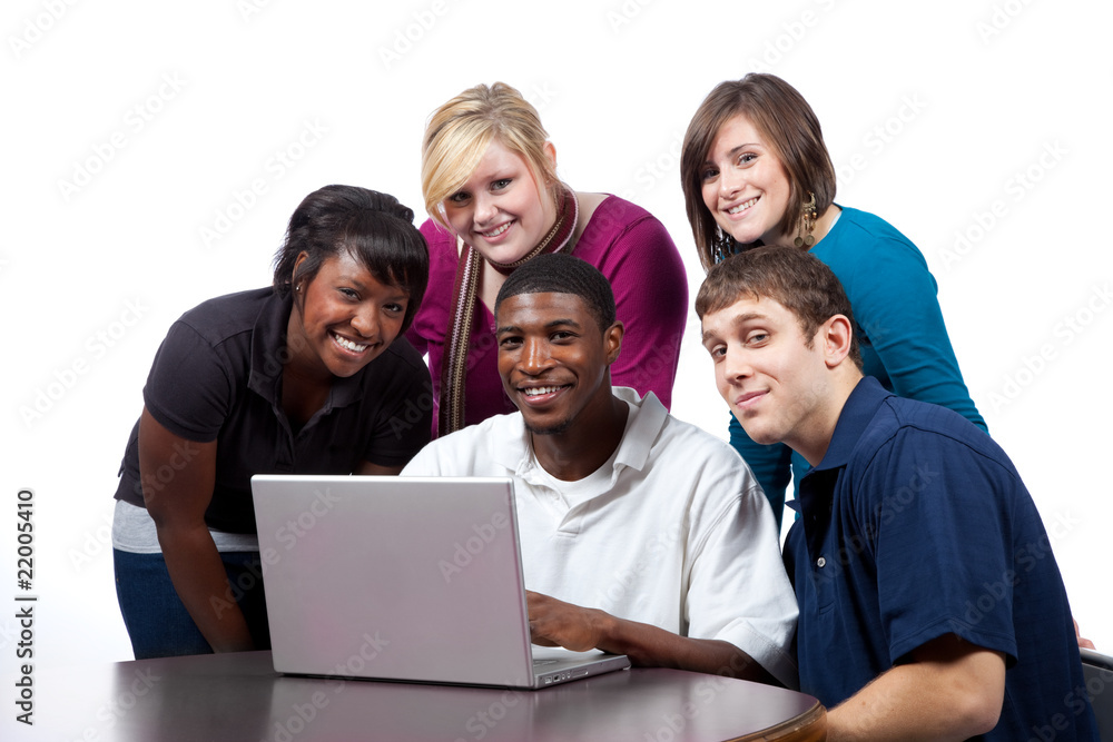 Multi-racial college students sitting around a computer Multi-racial college students sitting around a computer