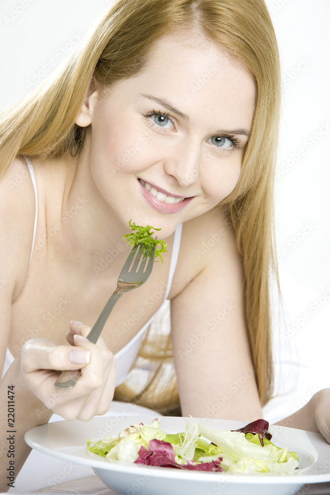 portrait of lying down woman eating salad portrait of lying down woman eating salad