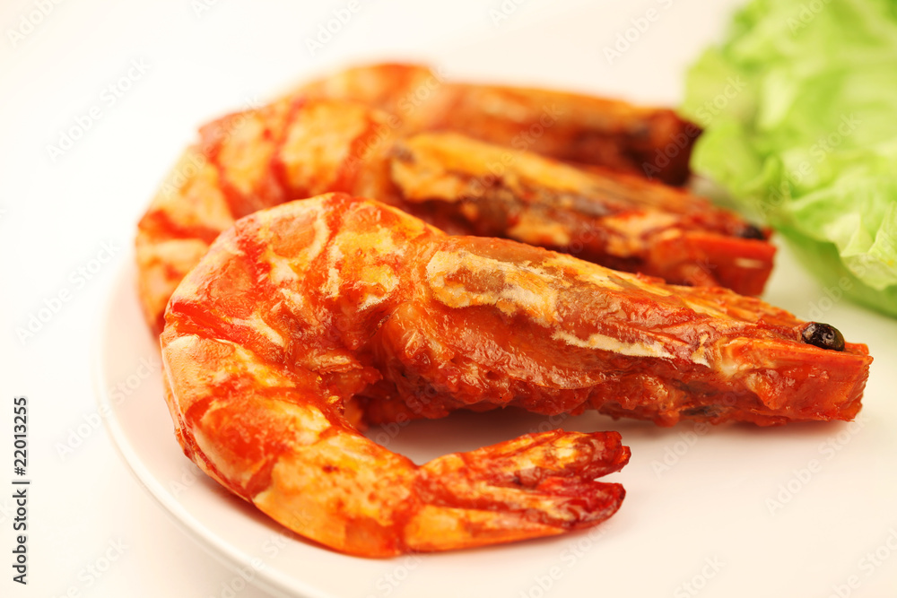 Asian cuisine. Seafood. Fried prawns on tomato sauce