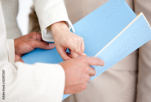 Close-up of a businesswoman pointing at a document
