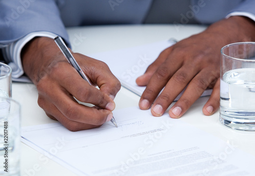 Close-up of ambitious business man signing a contract photo