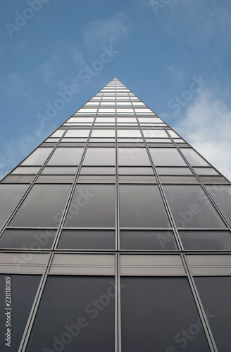 Triangular office business building against blue sky