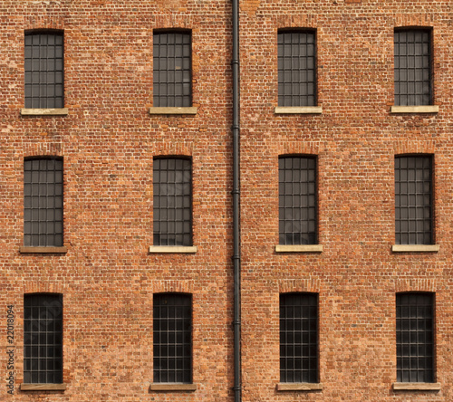 Old Orange Brick Wall with Twelve Windows and Gutter