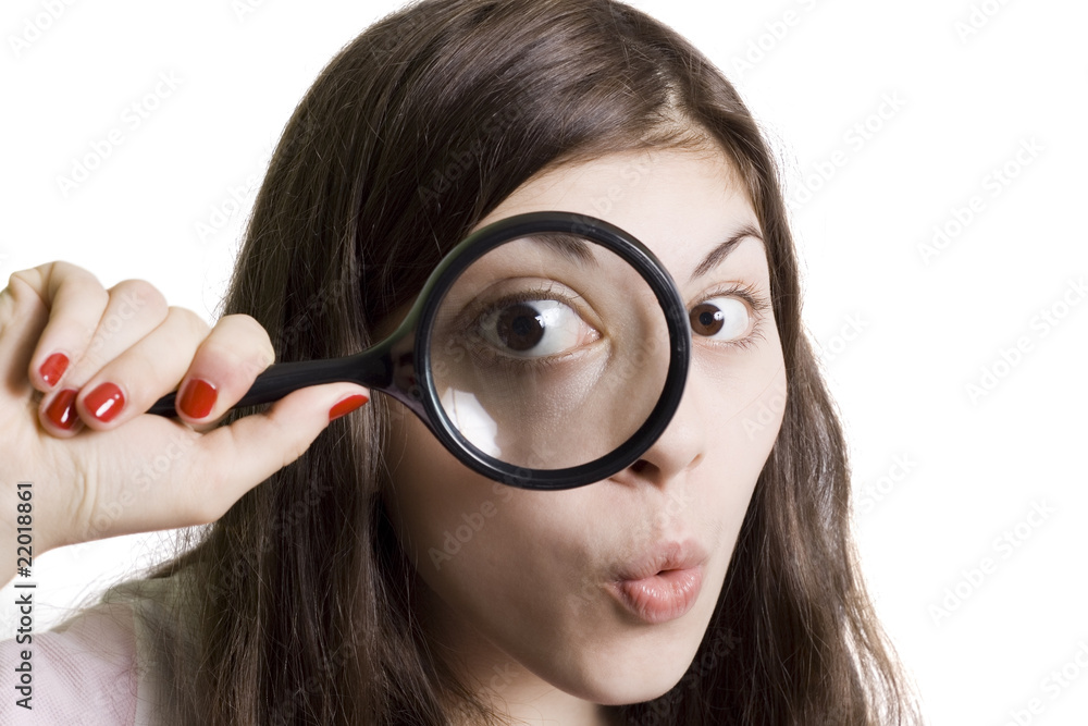 pretty young woman looking through magnifying pretty young woman looking through magnifying