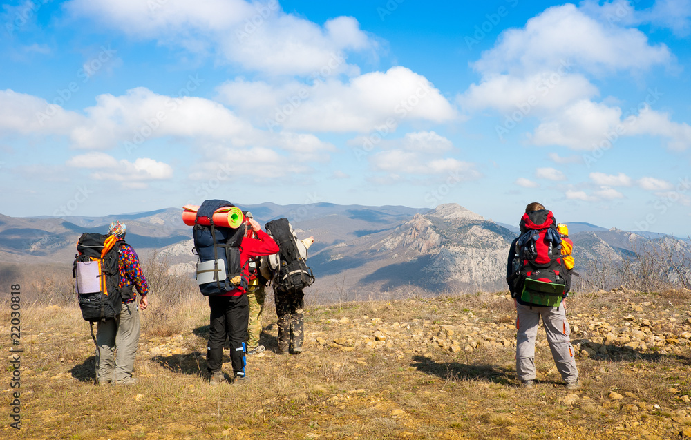 Hikers watch the terrain Hikers watch the terrain