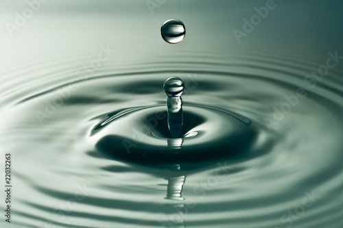 water droplet splashing in a dark water