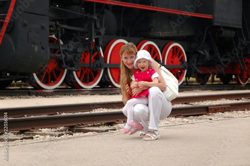 Woman with child beside locomotive