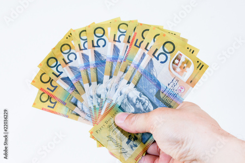 Australian fifty dollar notes in the hand.