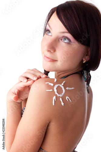 Young woman in bikini with sunscreen.