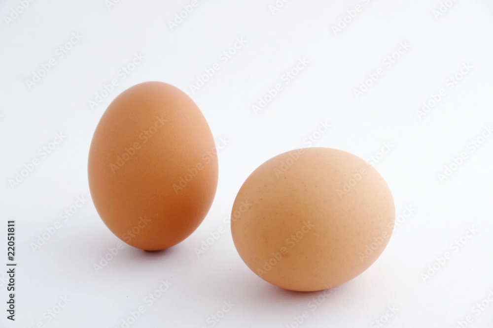 Two eggs with white background, one standing. Two eggs with white background, one standing.