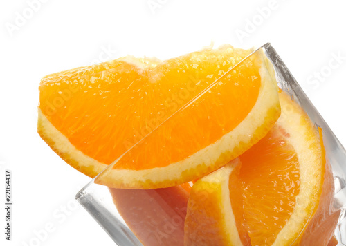 Orange slices in glass isolated on white background.