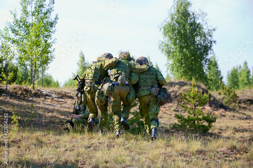 Two NATO Army soldiers escorted the wounded soldier