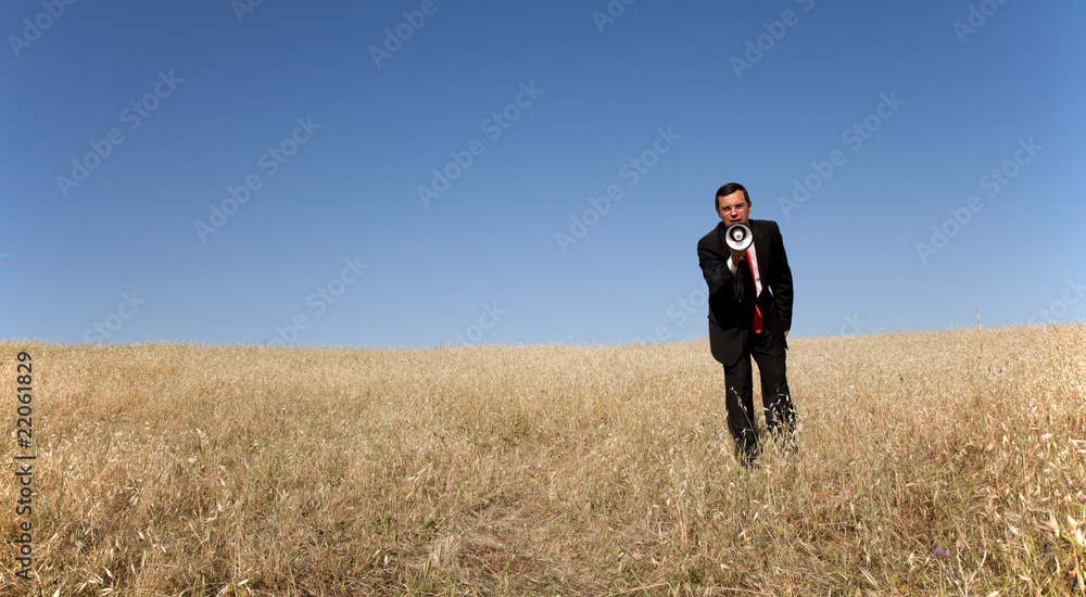 Businessman shouting at the megaphone to you Businessman shouting at the megaphone to you