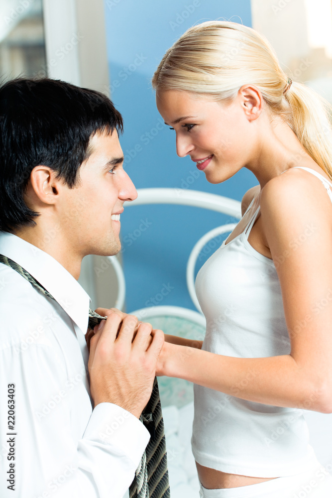 Young attractive happy amorous couple at bedroom Young attractive happy amorous couple at bedroom