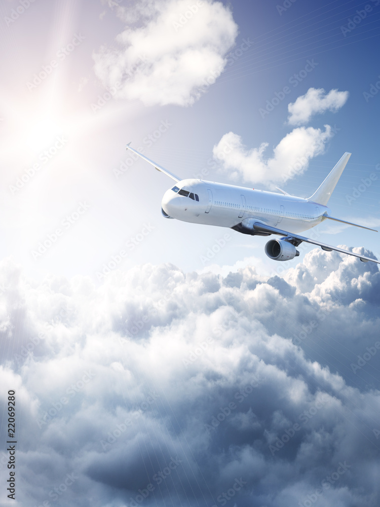 Fototapeta premium Samolot na niebie - pochmurny, ale słoneczny dzień