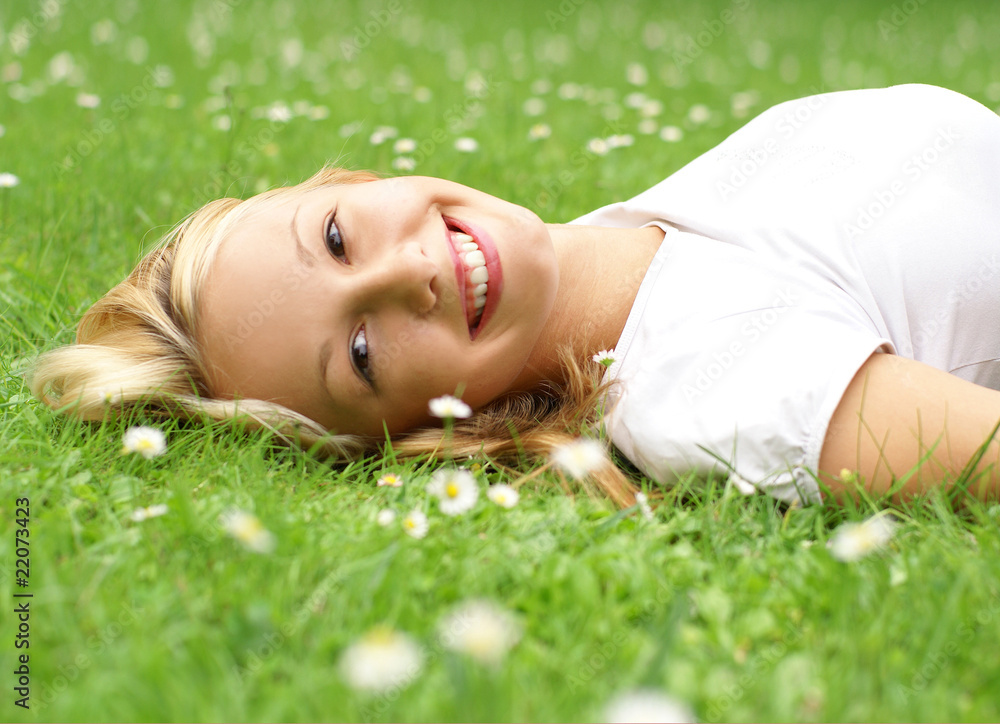 Portrait of a young blong girl relaxing on the grass Portrait of a young blong girl relaxing on the grass