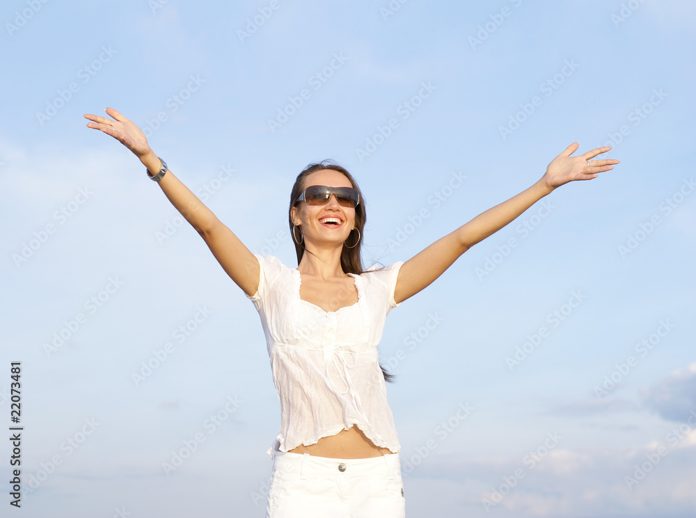 Young and happy woman on a cloudy background Young and happy woman on a cloudy background