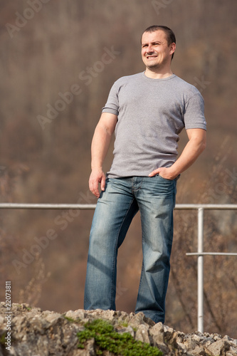 Young man full body portrait outdoors
