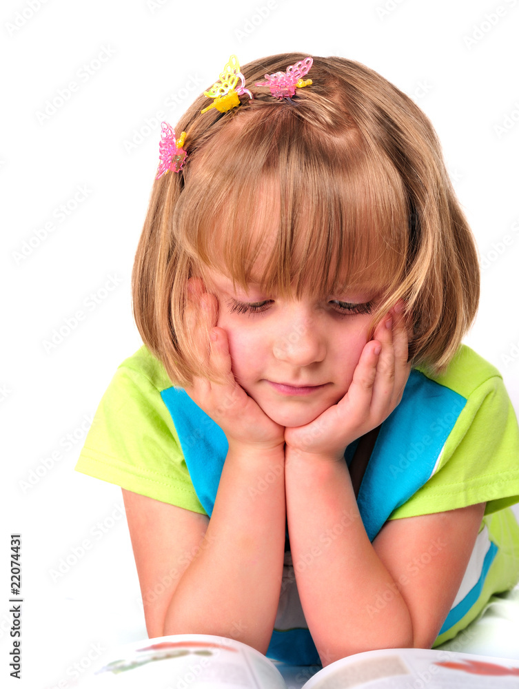 Cute little girl reading a magazine isolated over white Cute little girl reading a magazine isolated over white