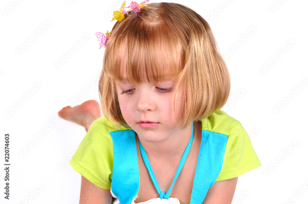 Cute little girl reading a magazine isolated over white Cute little girl reading a magazine isolated over white