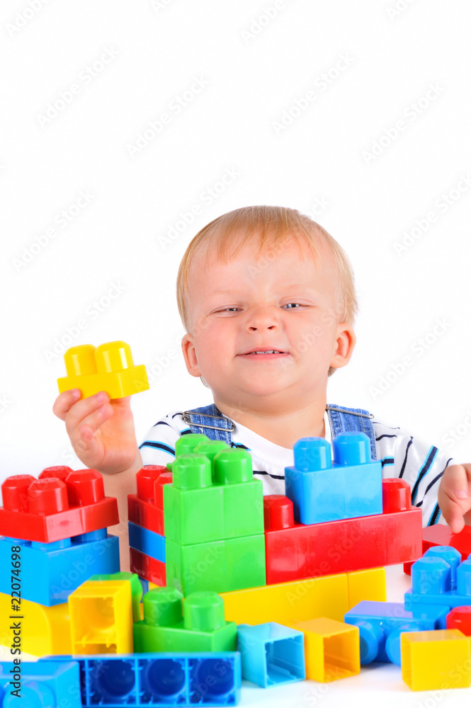 Cute little baby boy with colorful building blocks