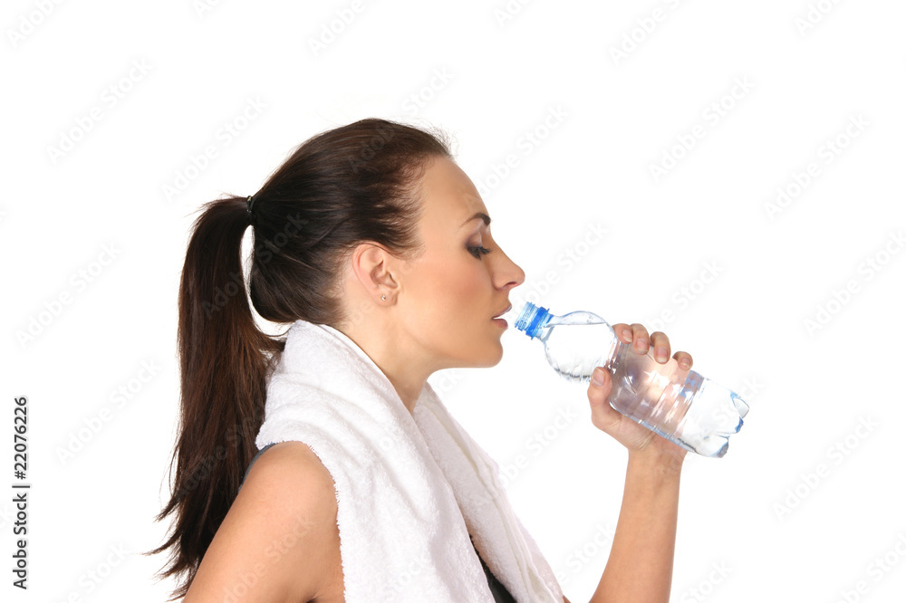 A young and sporty female drinking water after training A young and sporty female drinking water after training