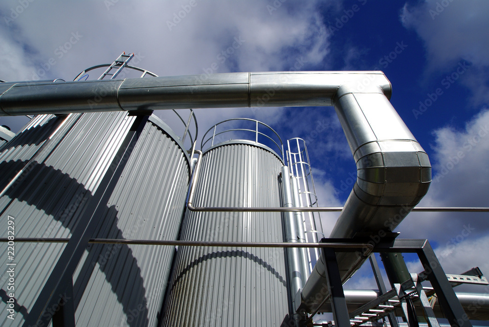 Naklejka premium Industrial zone, Steel pipe-lines on blue sky