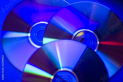 Slightly blurred compact discs in dark blue tones