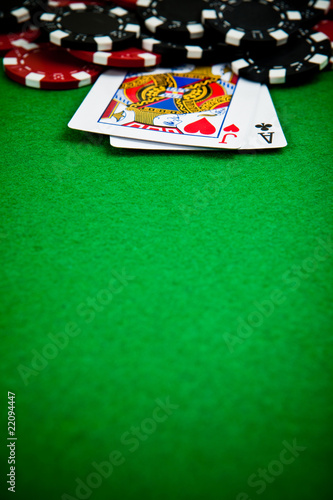 Black and red poker chips with cards in the background