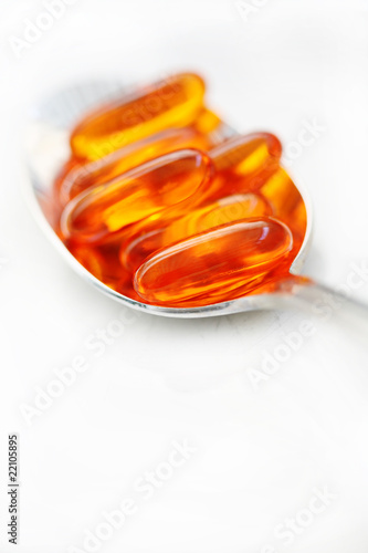 Vitamin Gel Caps On Spoon