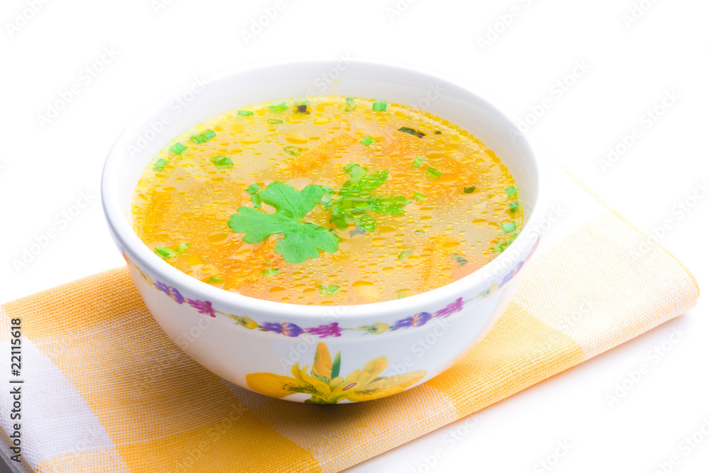 Bowl of chicken soup over yellow napkin Bowl of chicken soup over yellow napkin